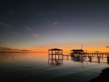 Silhouette pier on sea against sky during sunset