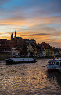 Boats in river at sunset