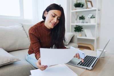 Young woman using laptop at home