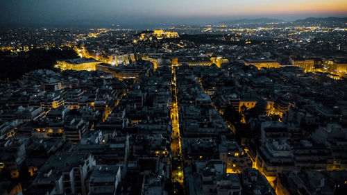 Aerial view of city lit up at night