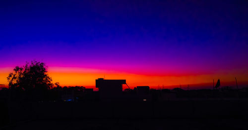 Silhouette landscape against sky at sunset