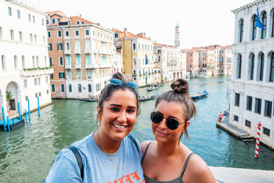 Portrait of smiling woman in canal in city