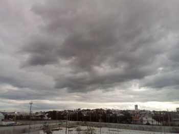 View of town against cloudy sky