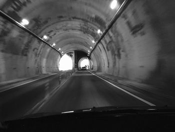 Illuminated tunnel at night