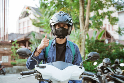 Side view of man riding motorcycle on road