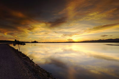 Scenic view of lake against sky during sunset