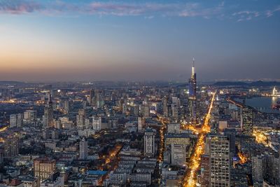 High angle view of city lit up at night