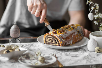 Midsection of man preparing food on table