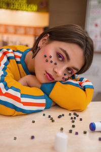 Portrait of girl lying on table at home
