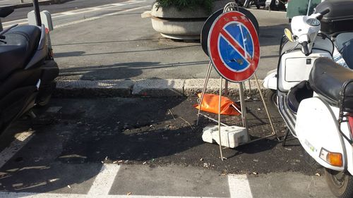 High angle view of road sign on street in city