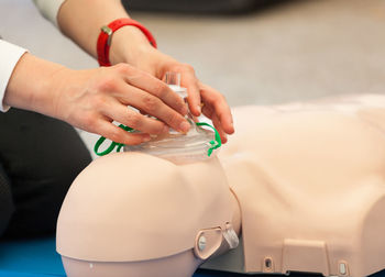 Midsection of woman holding bottle