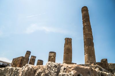 Low angle view of old ruins against blue sky