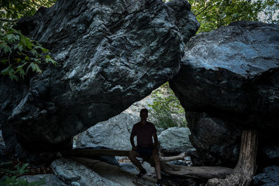 Rear view of man standing on rock