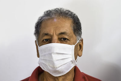 Portrait of mid adult man against white background