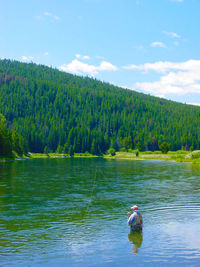 Rear view of man standing in water