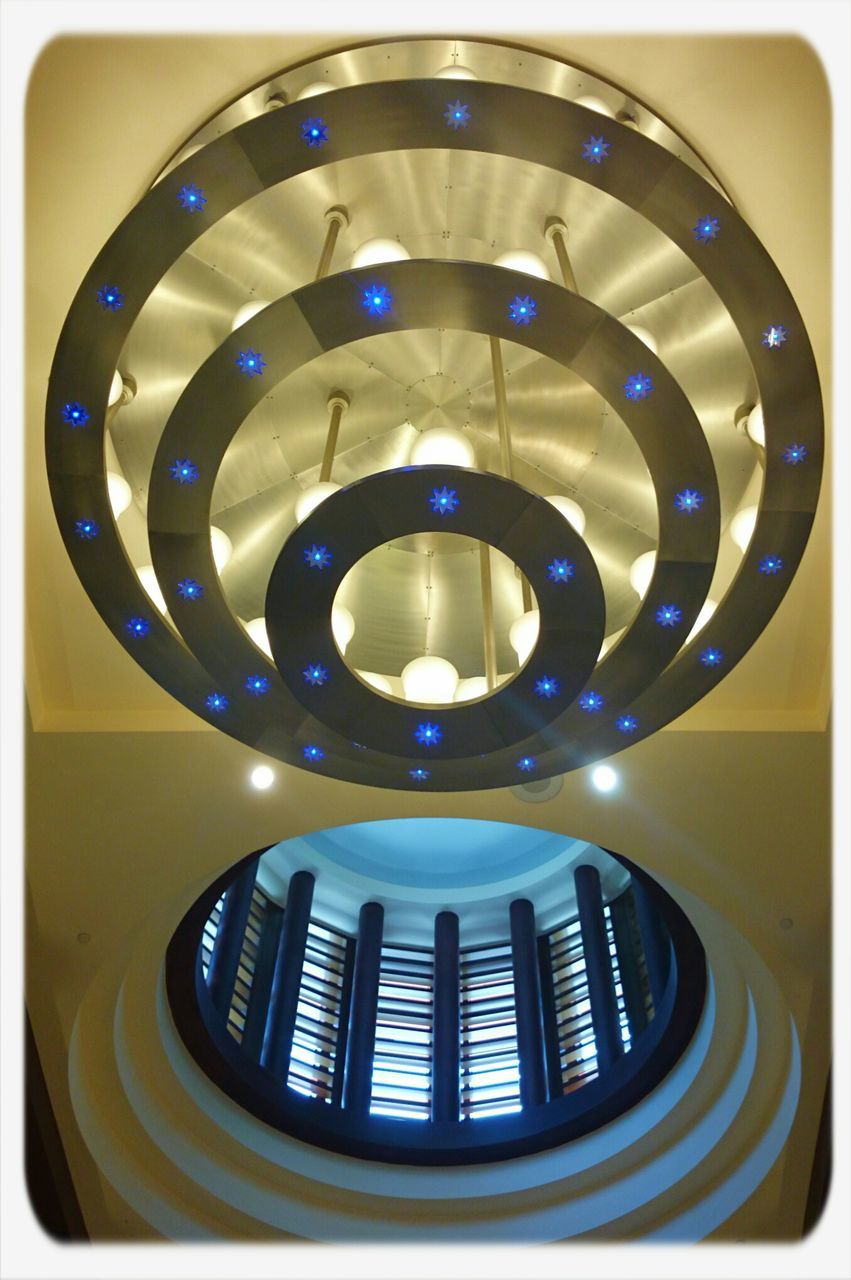 indoors, circle, transfer print, low angle view, pattern, auto post production filter, spiral, directly below, geometric shape, ceiling, close-up, illuminated, lighting equipment, shape, blue, modern, spiral staircase, no people, architecture, design