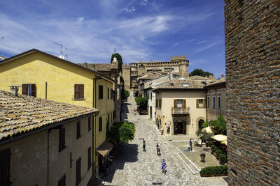 Buildings in town against sky