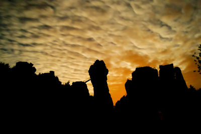 Silhouette people photographing against sky during sunset