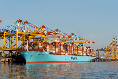 Commercial dock by sea against sky