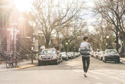 Full length rear view of man on street