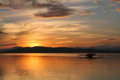 Boat in sea at sunset