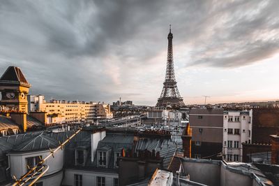 View of cityscape against cloudy sky