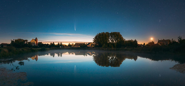 Scenic view of lake against sky at night