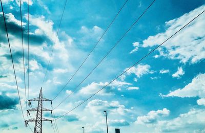 Low angle view of electricity pylon against sky