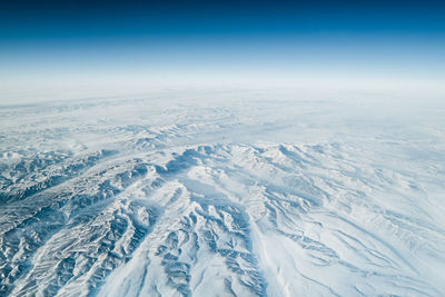 Aerial view of landscape against blue sky