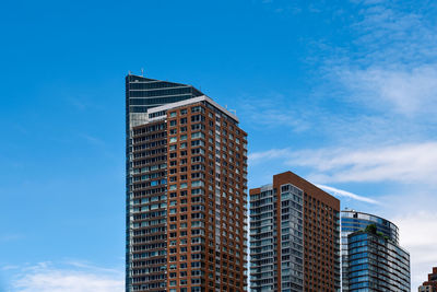 Low angle view of modern building against blue sky