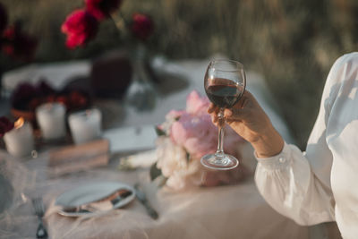 Midsection of woman drinking glass