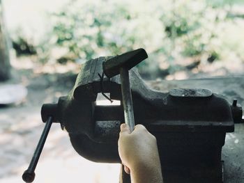 Close-up of hand holding metal