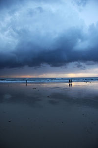 Scenic view of beach against sky during sunset