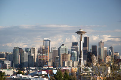 View of cityscape against cloudy sky