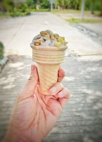 Close-up of hand holding ice cream