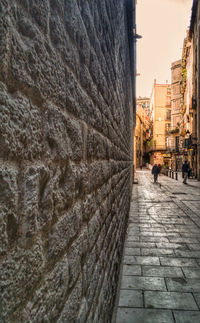 People walking on footpath amidst buildings