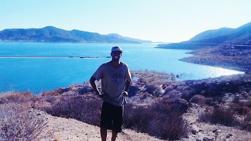 Rear view of man looking at lake