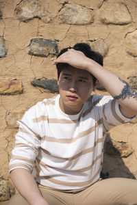 Portrait of young man sitting outdoors