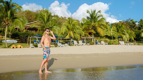 Full length of woman standing at beach