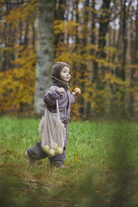 Portrait of young woman standing on field