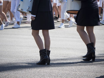 Low section of women standing on city street