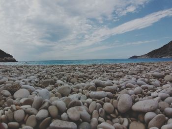 Rocks on beach against sky