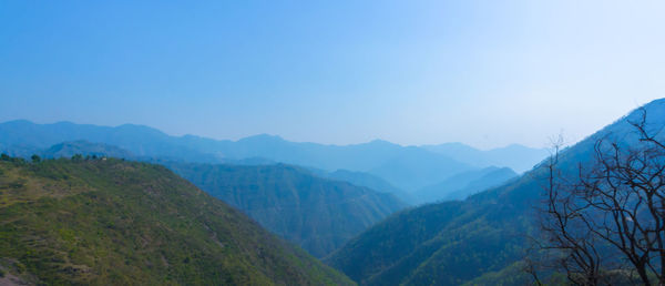 Scenic view of mountains against clear blue sky