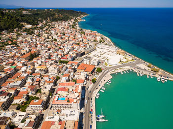 High angle view of townscape by sea against sky