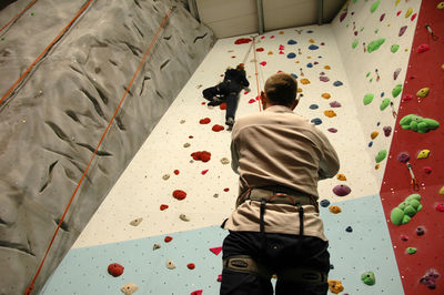Man climbing wall at training class