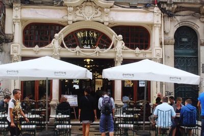 People in traditional building in city
