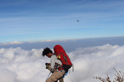 Side view of father and son against sky