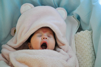 Portrait of cute baby boy sleeping on bed at home