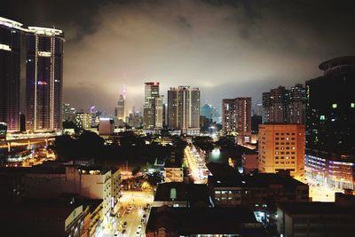 High angle view of city lit up at night