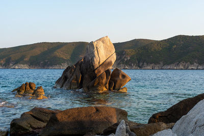 Nearshore rocks standing from the sea